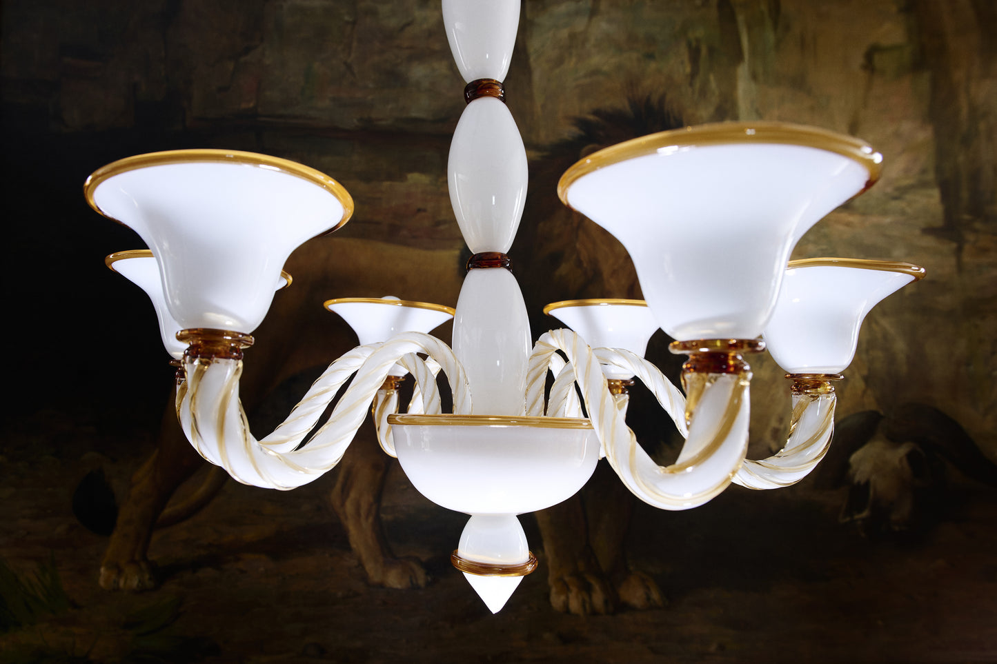 Long Murano glass chandelier in opal and amber hanging from ceiling.