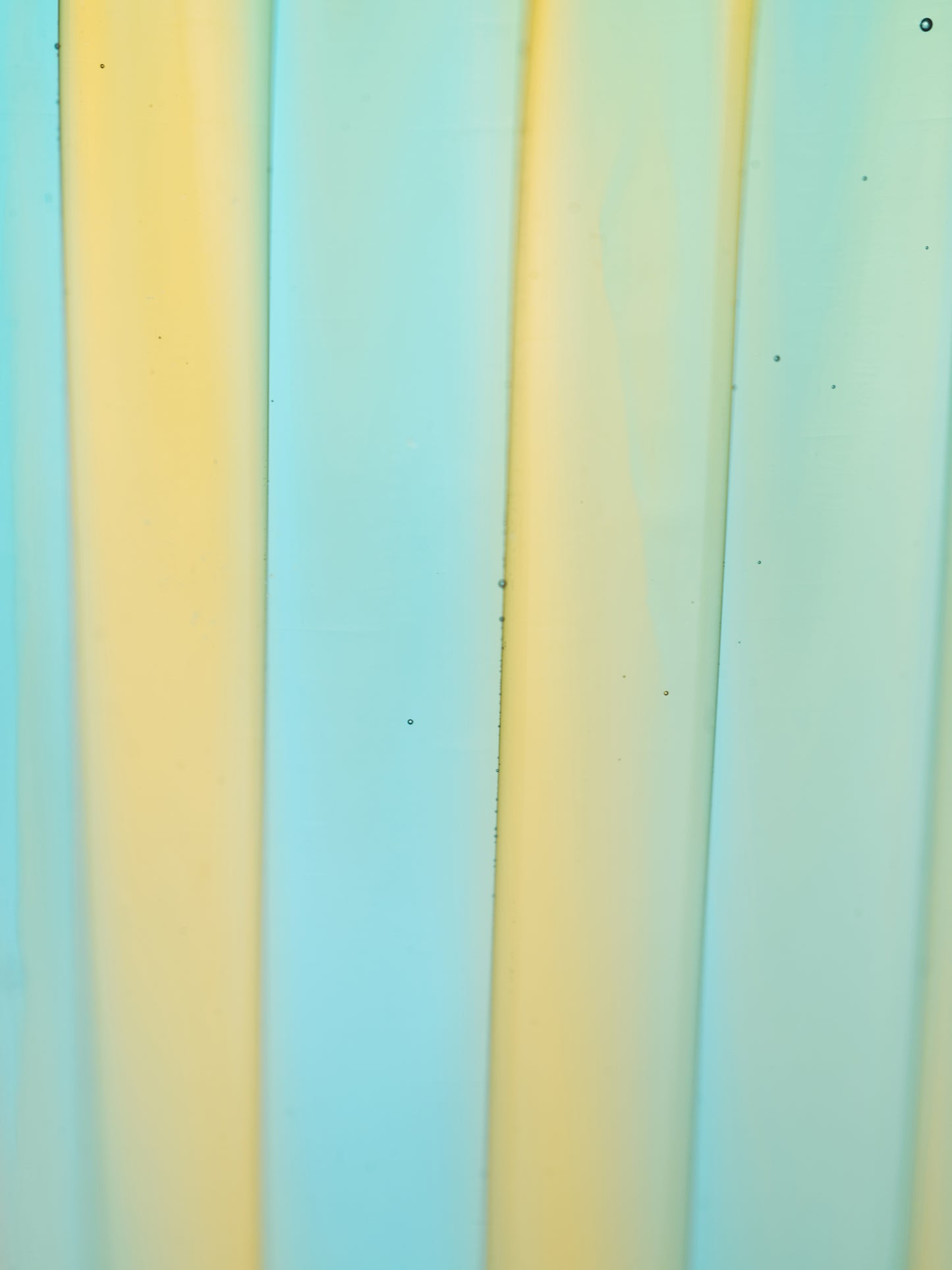 Striped color swatch of handmade Murano glass in blue and yellow.