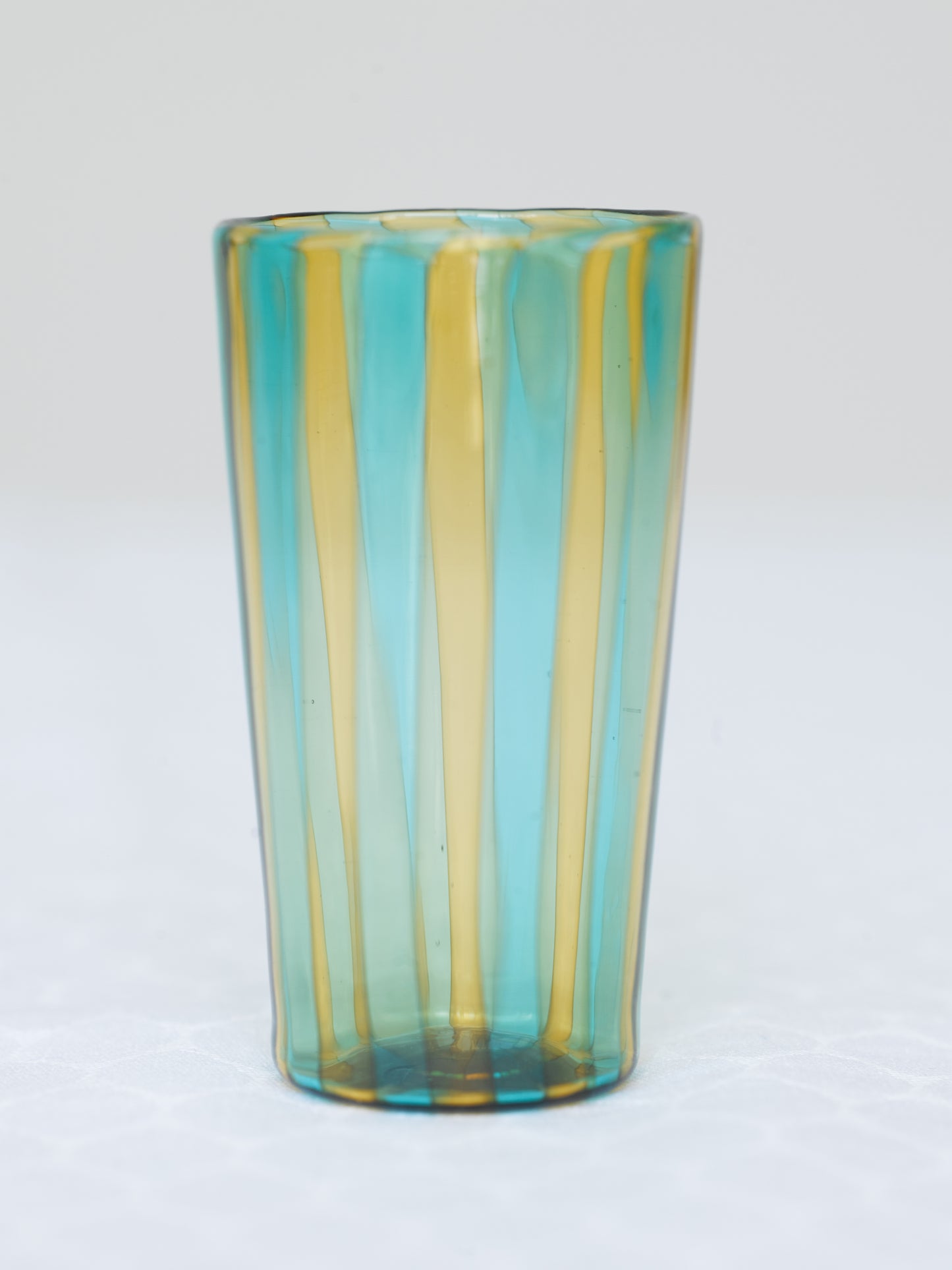 Small striped handmade Murano glass in blue and yellow.