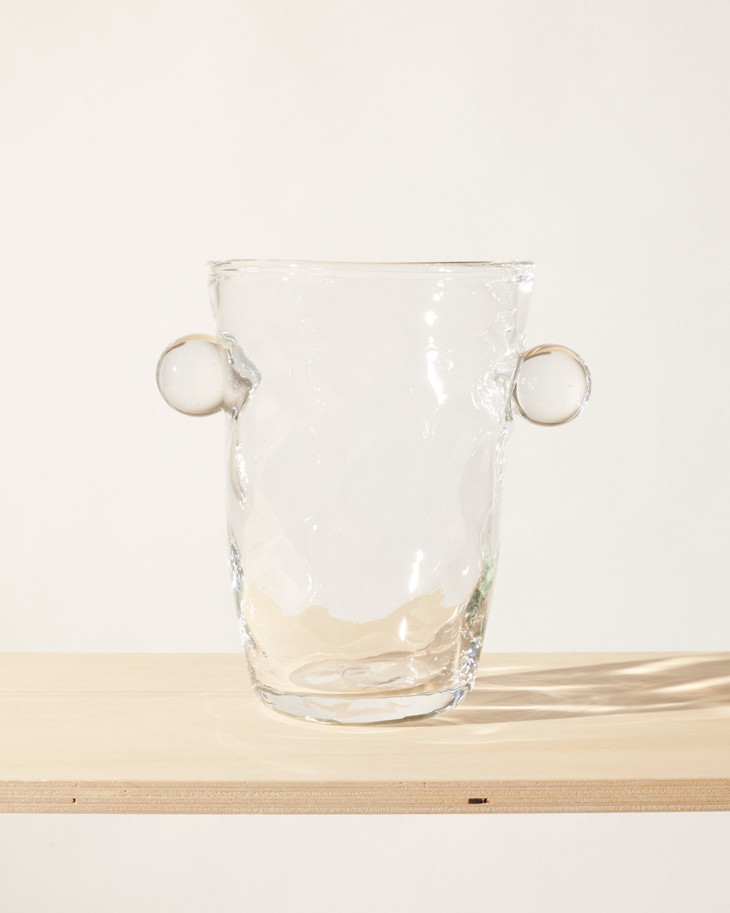 Akua Objects Glassware. Mouth blown and handmade Bohemian Glassware. Made in Bohemia. The Oliver vase is named after friend and muse of Akua Objects, Oliver Fussing. Different shapes meet and create a sculptural silhouette. The Oliver vase could have been born during the art deco period and act as a contemporary piece in Akua Object’s poetic universe. It takes four people to create each Oliver vase.
