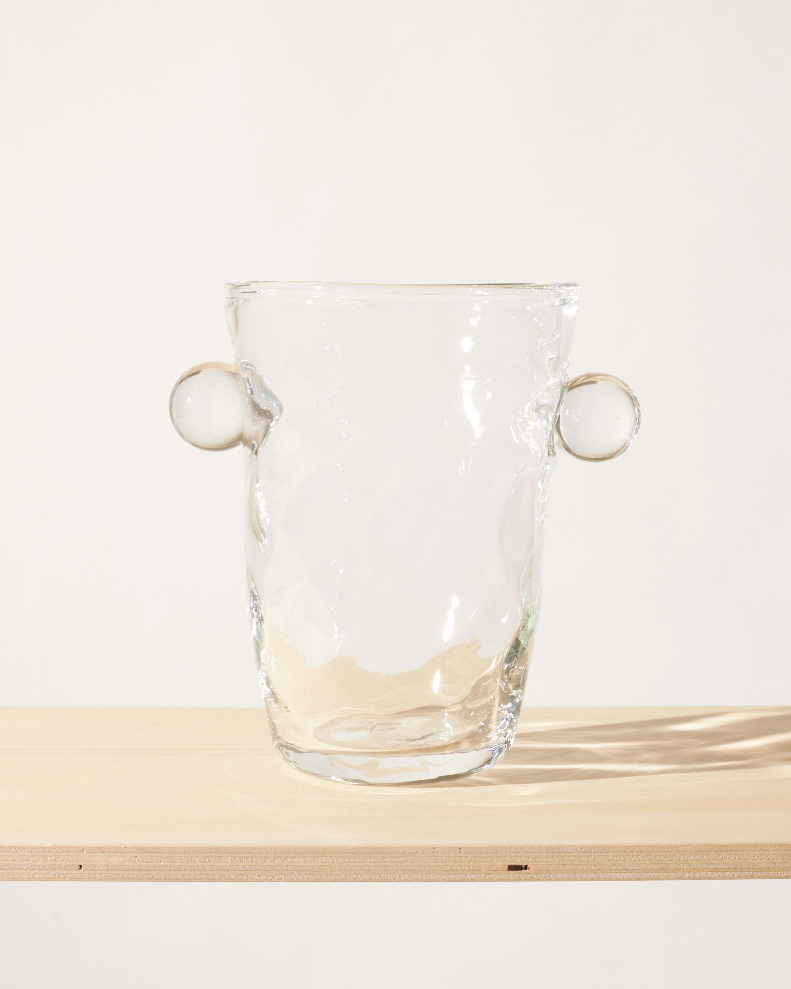 Akua Objects Glassware. Mouth blown and handmade Bohemian Glassware. Made in Bohemia. The Oliver vase is named after friend and muse of Akua Objects, Oliver Fussing. Different shapes meet and create a sculptural silhouette. The Oliver vase could have been born during the art deco period and act as a contemporary piece in Akua Object’s poetic universe. It takes four people to create each Oliver vase.