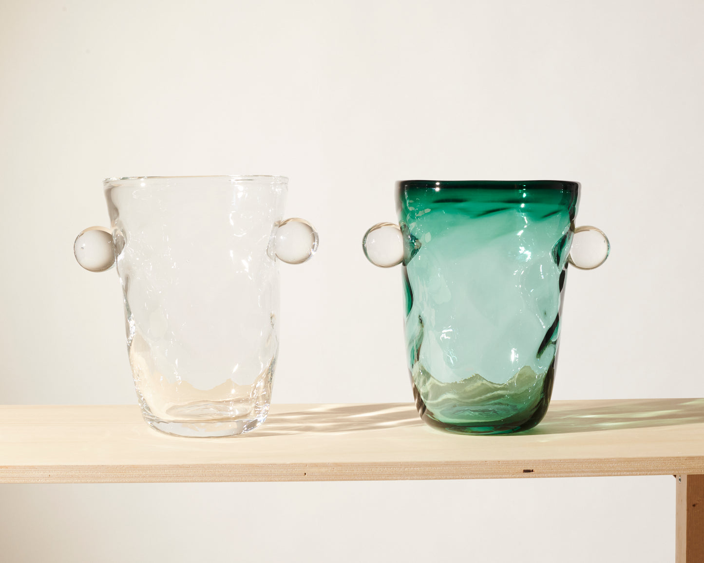 Akua Objects Glassware. Mouth blown and handmade Bohemian Glassware. Made in Bohemia. The Oliver vase is named after friend and muse of Akua Objects, Oliver Fussing. Different shapes meet and create a sculptural silhouette. The Oliver vase could have been born during the art deco period and act as a contemporary piece in Akua Object’s poetic universe. It takes four people to create each Oliver vase.