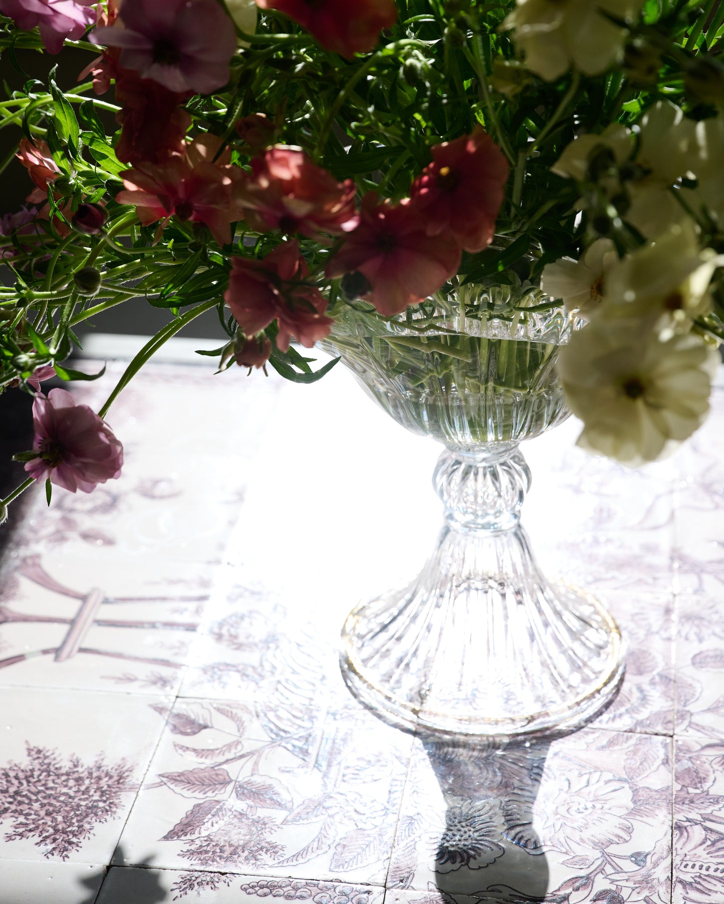 Large mouth blown clear Murano vase with flowers.