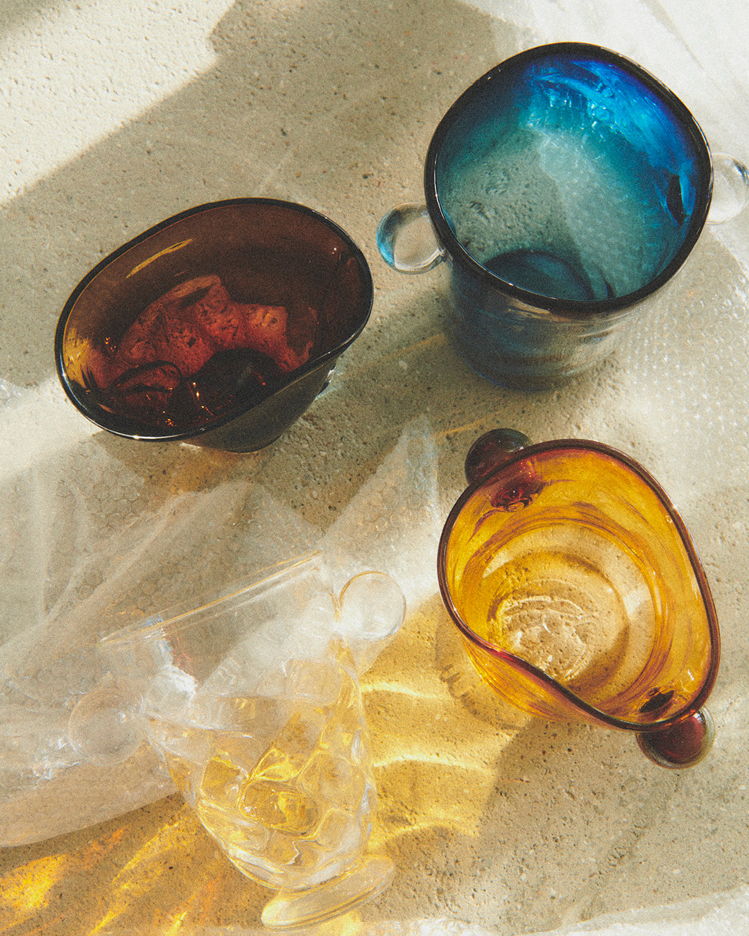 Akua Objects Glassware. Mouth blown and handmade Bohemian Glassware. Made in Bohemia. The Oliver vase is named after friend and muse of Akua Objects, Oliver Fussing. Different shapes meet and create a sculptural silhouette. The Oliver vase could have been born during the art deco period and act as a contemporary piece in Akua Object’s poetic universe. It takes four people to create each Oliver vase.