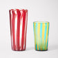 Small and large striped handmade Murano glasses in red, blue and yellow.