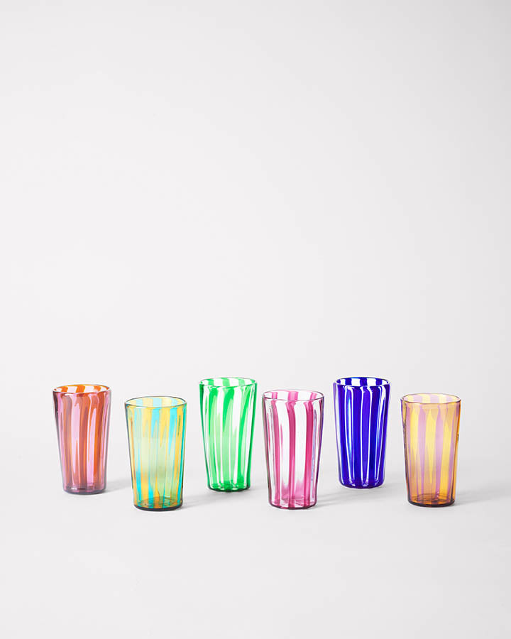 Six small striped handmade glasses in vibrant colors made in Murano.